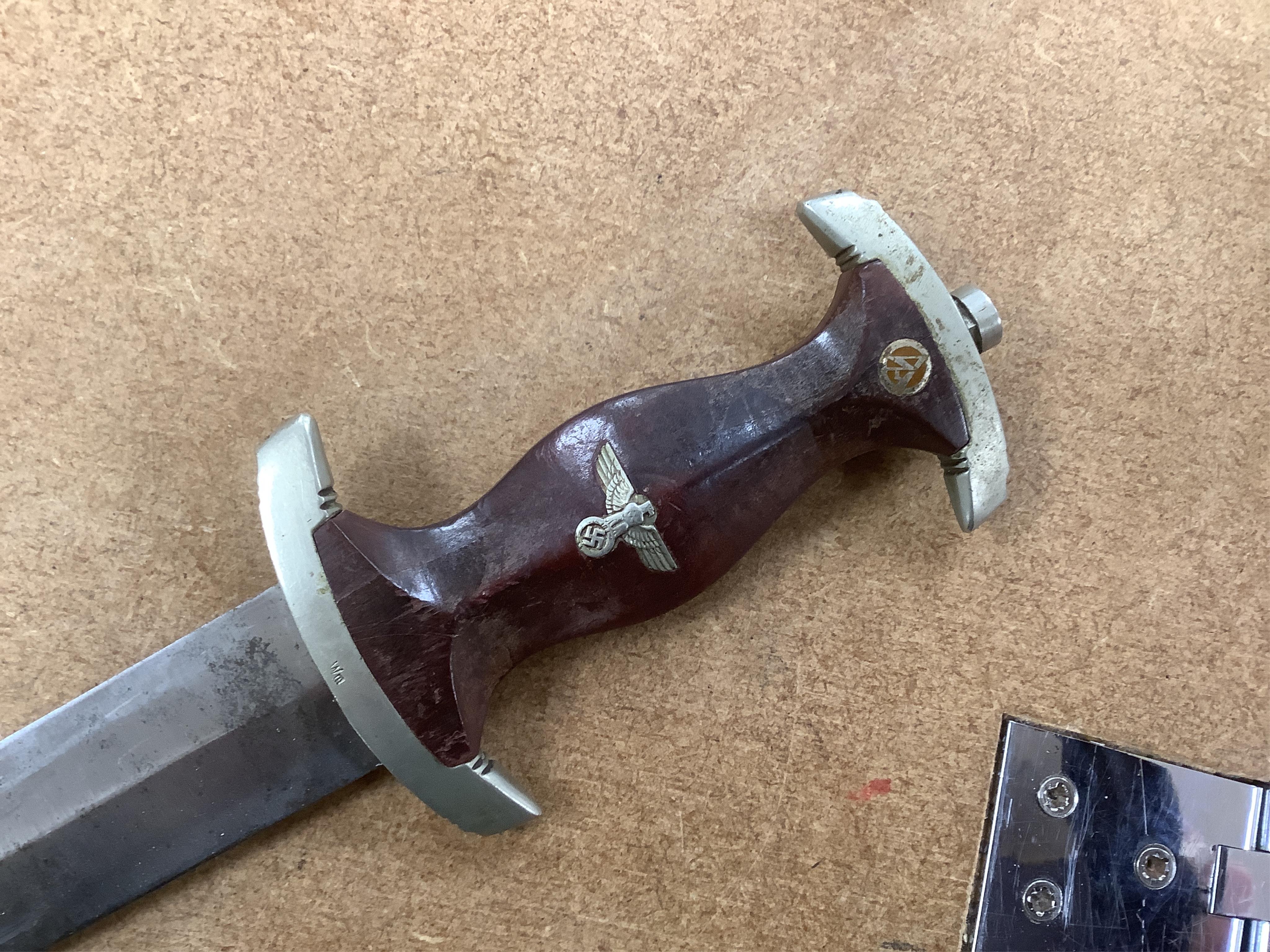 A WWII German SA dagger, regulation pattern in its steel scabbard with regulation nickel mounts, and leather hanging band and a German dress bayonet by Paul Seilheimer. Condition - fair, some wear